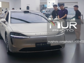 Customers are experiencing the Stelato 9, a smart luxury pure electric car, at a Huawei store in Hangzhou, China, on July 24, 2024. (