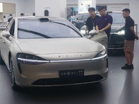 Customers are experiencing the Stelato 9, a smart luxury pure electric car, at a Huawei store in Hangzhou, China, on July 24, 2024. (