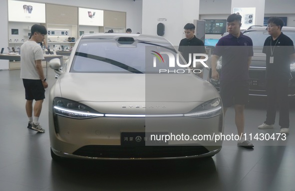 Customers are experiencing the Stelato 9, a smart luxury pure electric car, at a Huawei store in Hangzhou, China, on July 24, 2024. 