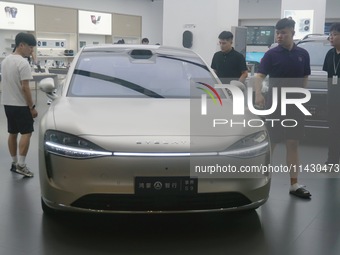 Customers are experiencing the Stelato 9, a smart luxury pure electric car, at a Huawei store in Hangzhou, China, on July 24, 2024. (