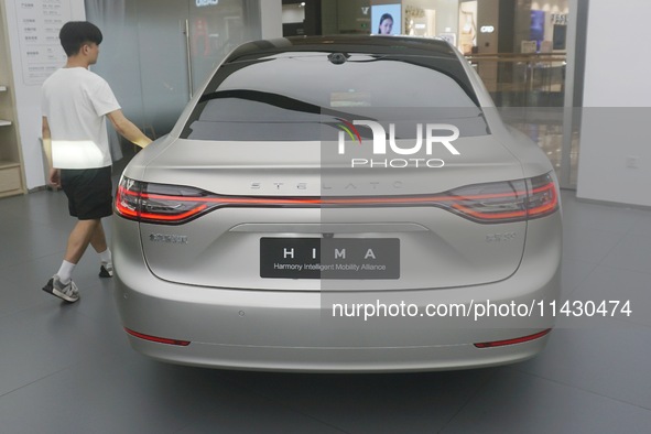 Customers are experiencing the Stelato 9, a smart luxury pure electric car, at a Huawei store in Hangzhou, China, on July 24, 2024. 