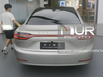 Customers are experiencing the Stelato 9, a smart luxury pure electric car, at a Huawei store in Hangzhou, China, on July 24, 2024. (