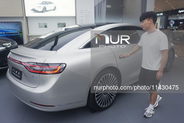 Customers are experiencing the Stelato 9, a smart luxury pure electric car, at a Huawei store in Hangzhou, China, on July 24, 2024. 