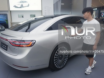 Customers are experiencing the Stelato 9, a smart luxury pure electric car, at a Huawei store in Hangzhou, China, on July 24, 2024. (