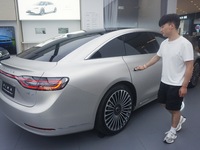 Customers are experiencing the Stelato 9, a smart luxury pure electric car, at a Huawei store in Hangzhou, China, on July 24, 2024. (