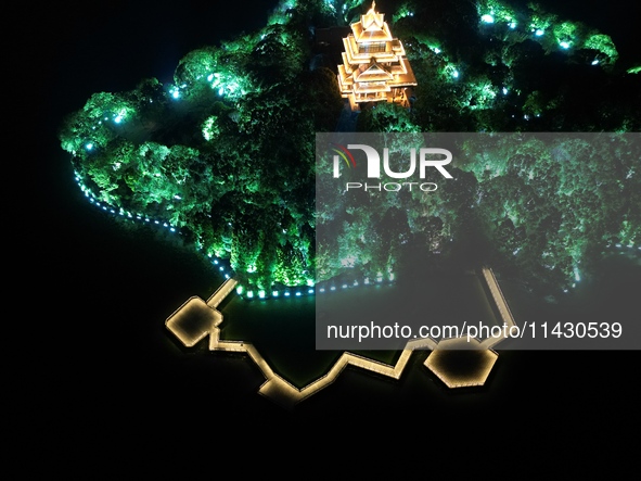 A photo is showing the night view of Moonlight Pier, a business district in Suzhou, Jiangsu province, China, on May 29, 2024. 