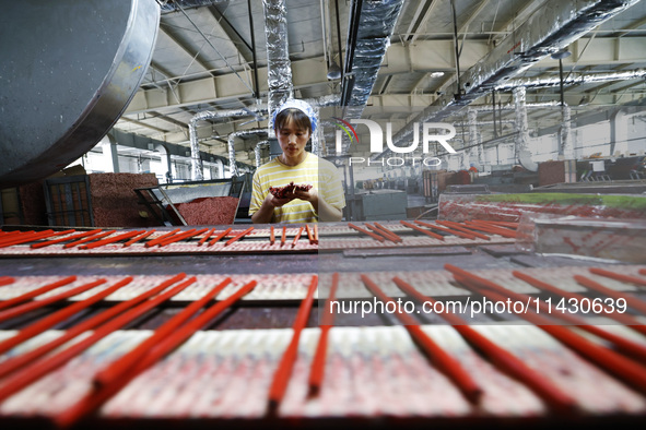 A worker is producing pencils at a production workshop in Suqian, Jiangsu province, China, on July 24, 2024. 