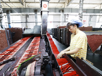 A worker is producing pencils at a production workshop in Suqian, Jiangsu province, China, on July 24, 2024. (