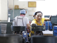 A worker is producing pencils at a production workshop in Suqian, Jiangsu province, China, on July 24, 2024. (