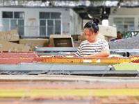 A worker is producing pencils at a production workshop in Suqian, Jiangsu province, China, on July 24, 2024. (