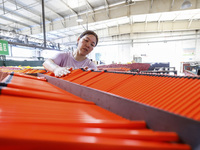 A worker is producing pencils at a production workshop in Suqian, Jiangsu province, China, on July 24, 2024. (