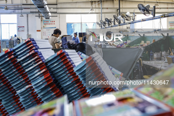 A worker is producing pencils at a production workshop in Suqian, Jiangsu province, China, on July 24, 2024. 