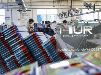 A worker is producing pencils at a production workshop in Suqian, Jiangsu province, China, on July 24, 2024. (