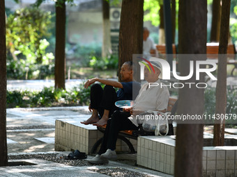 Senior citizens are relaxing at a park in Fuyang, China, on July 22, 2024. (