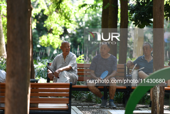 Senior citizens are relaxing at a park in Fuyang, China, on July 22, 2024. 