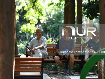 Senior citizens are relaxing at a park in Fuyang, China, on July 22, 2024. (