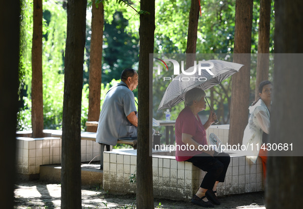 Senior citizens are relaxing at a park in Fuyang, China, on July 22, 2024. 