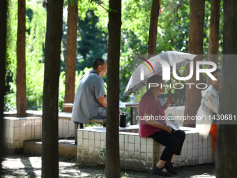 Senior citizens are relaxing at a park in Fuyang, China, on July 22, 2024. (