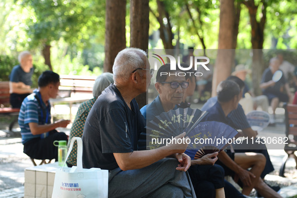 Senior citizens are relaxing at a park in Fuyang, China, on July 22, 2024. 