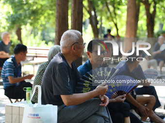 Senior citizens are relaxing at a park in Fuyang, China, on July 22, 2024. (