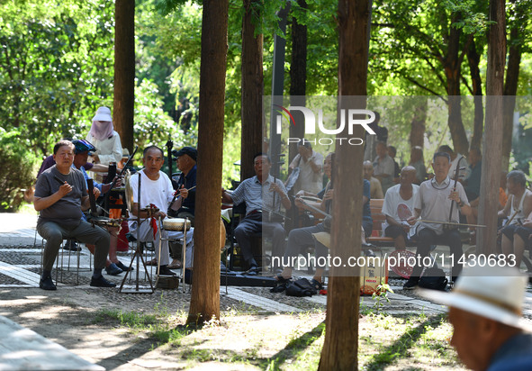 Senior citizens are relaxing at a park in Fuyang, China, on July 22, 2024. 