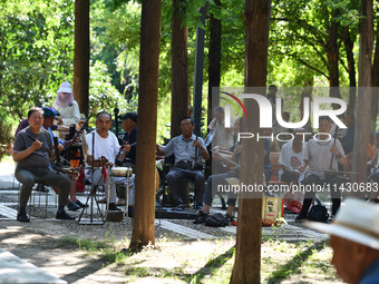 Senior citizens are relaxing at a park in Fuyang, China, on July 22, 2024. (