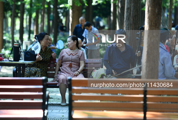 Senior citizens are relaxing at a park in Fuyang, China, on July 22, 2024. 