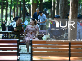 Senior citizens are relaxing at a park in Fuyang, China, on July 22, 2024. (