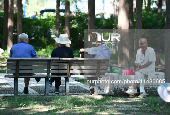 Senior citizens are relaxing at a park in Fuyang, China, on July 22, 2024. 