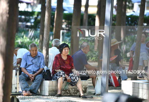 Senior citizens are relaxing at a park in Fuyang, China, on July 22, 2024. 