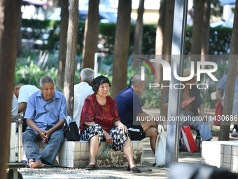 Senior citizens are relaxing at a park in Fuyang, China, on July 22, 2024. (