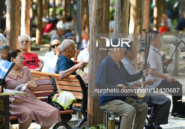 Senior citizens are relaxing at a park in Fuyang, China, on July 22, 2024. 