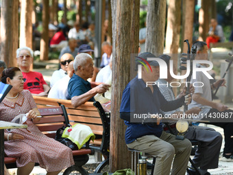 Senior citizens are relaxing at a park in Fuyang, China, on July 22, 2024. (