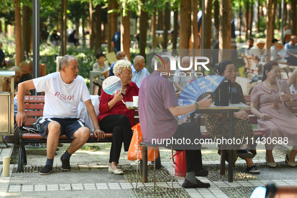 Senior citizens are relaxing at a park in Fuyang, China, on July 22, 2024. 