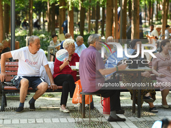 Senior citizens are relaxing at a park in Fuyang, China, on July 22, 2024. (