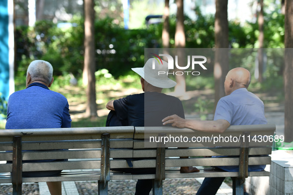 Senior citizens are relaxing at a park in Fuyang, China, on July 22, 2024. 