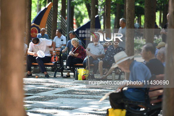 Senior citizens are relaxing at a park in Fuyang, China, on July 22, 2024. 