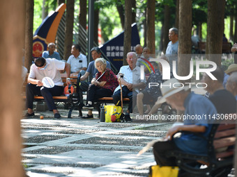 Senior citizens are relaxing at a park in Fuyang, China, on July 22, 2024. (