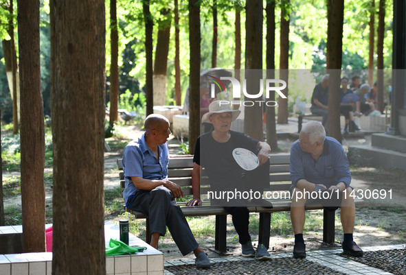 Senior citizens are relaxing at a park in Fuyang, China, on July 22, 2024. 