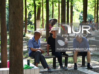 Senior citizens are relaxing at a park in Fuyang, China, on July 22, 2024. (