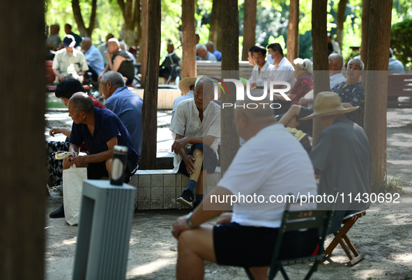 Senior citizens are relaxing at a park in Fuyang, China, on July 22, 2024. 