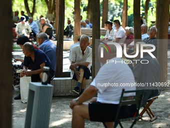 Senior citizens are relaxing at a park in Fuyang, China, on July 22, 2024. (