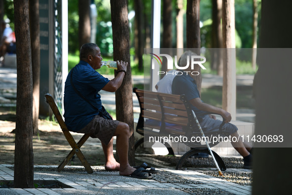 Senior citizens are relaxing at a park in Fuyang, China, on July 22, 2024. 