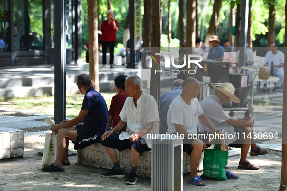 Senior citizens are relaxing at a park in Fuyang, China, on July 22, 2024. 