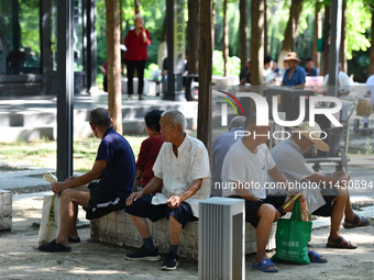 Senior citizens are relaxing at a park in Fuyang, China, on July 22, 2024. (