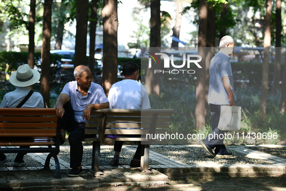 Senior citizens are relaxing at a park in Fuyang, China, on July 22, 2024. 