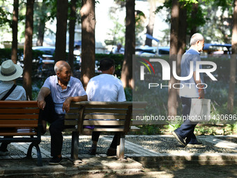 Senior citizens are relaxing at a park in Fuyang, China, on July 22, 2024. (