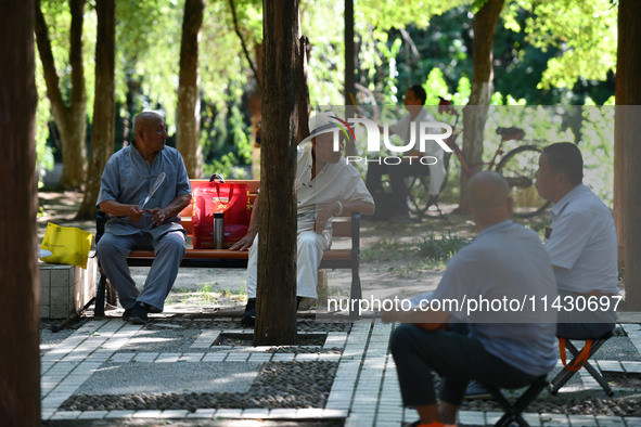 Senior citizens are relaxing at a park in Fuyang, China, on July 22, 2024. 