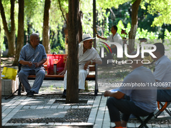 Senior citizens are relaxing at a park in Fuyang, China, on July 22, 2024. (