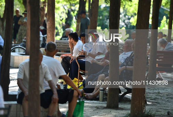 Senior citizens are relaxing at a park in Fuyang, China, on July 22, 2024. 